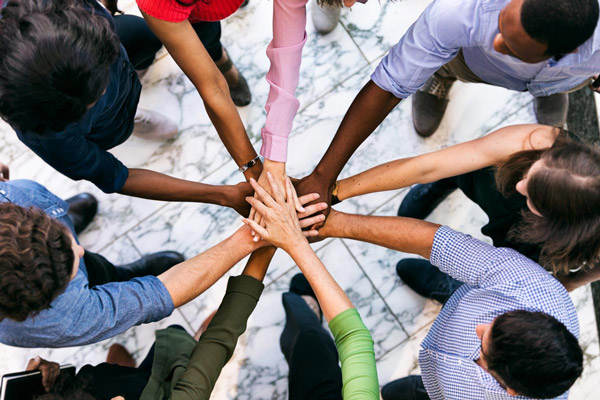 Group of hands holding eachother, symbolizing unity and support.